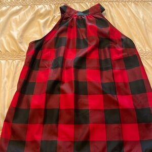 Sleeveless black and red blouse with tie back.